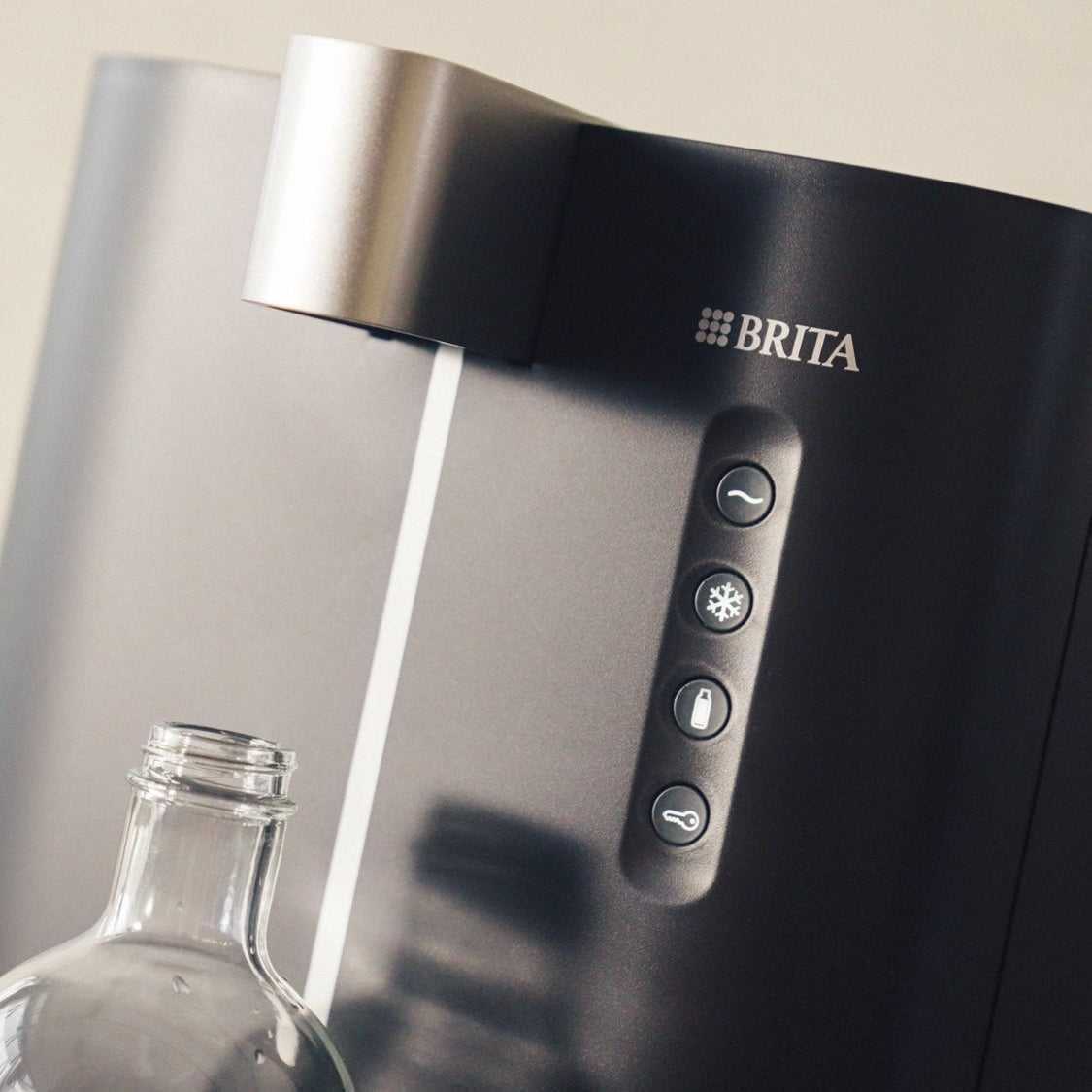 BRITA Top Compact with a clear bottle underneath in a neutral background.
